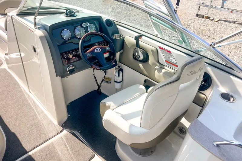 Slide: The Image of 2007 Sea Ray 260 Sundeck helm with steering wheel and control panel. - 12