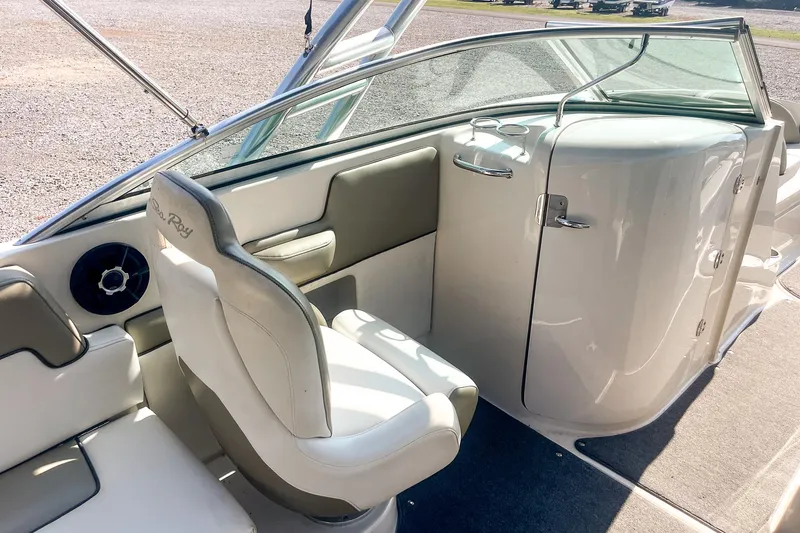 Slide: The Image of 2007 Sea Ray 260 Sundeck interior with white seating and sleek dashboard design. - 14