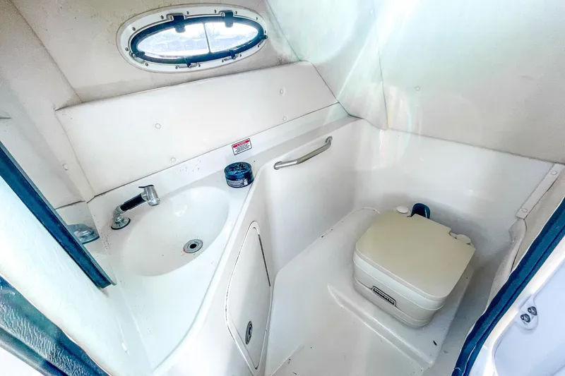 Slide: The Image of 2007 Sea Ray 260 Sundeck boat bathroom with sink and portable toilet. - 15