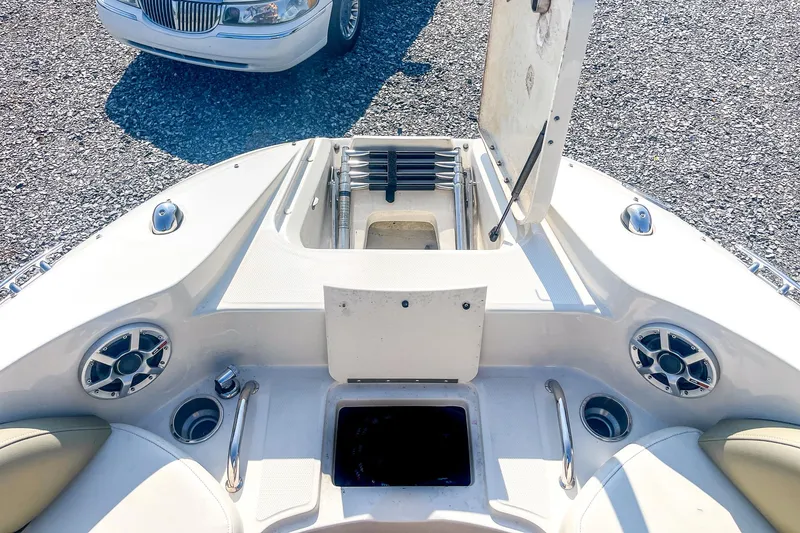 Slide: The Image of 2007 Sea Ray 260 Sundeck interior with open storage compartment and speakers. - 17