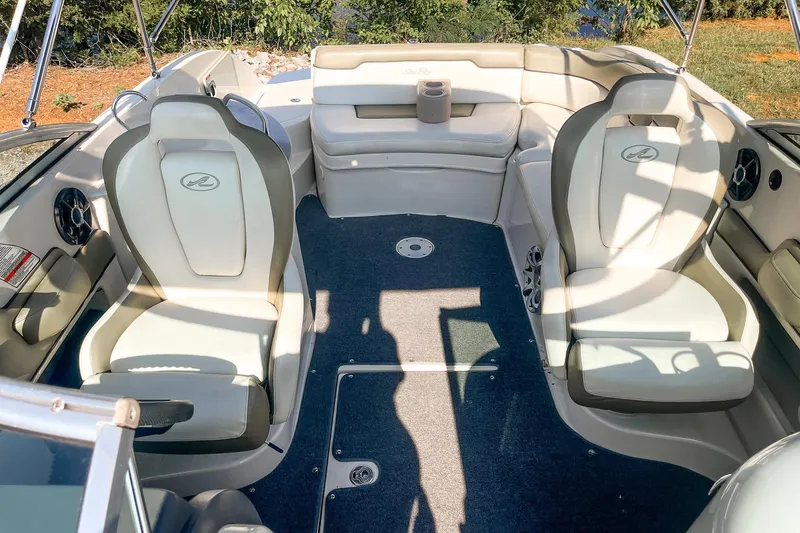 Slide: The Image of 2007 Sea Ray 260 Sundeck interior with plush seating and carpeted flooring. - 18