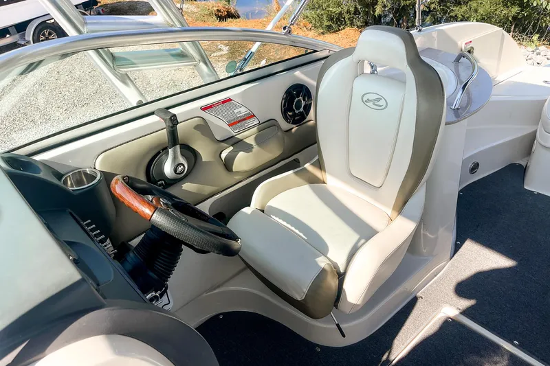 Slide: The Image of 2007 Sea Ray 260 Sundeck cockpit with steering wheel and captain's chair. - 19