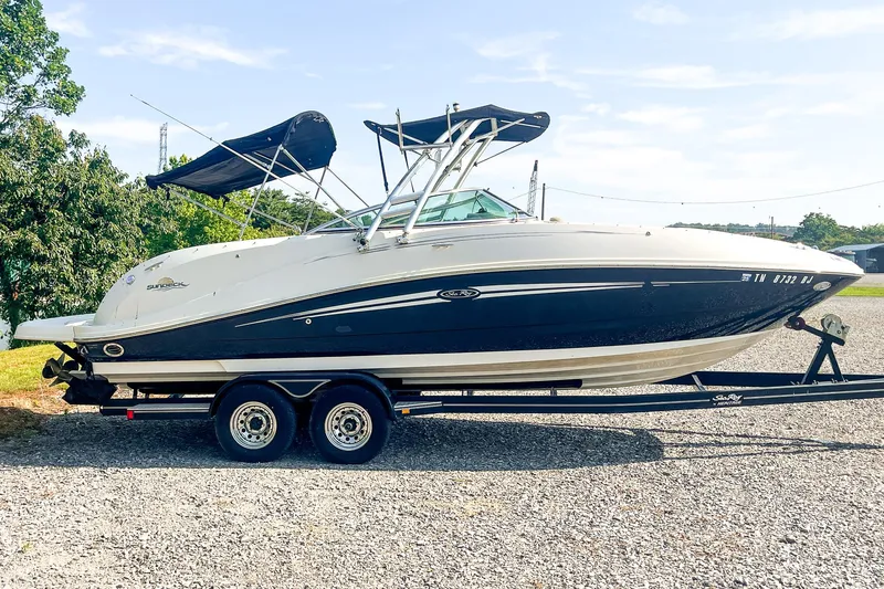 Slide: The Image of 2007 Sea Ray 260 Sundeck boat on trailer, parked outdoors. - 2