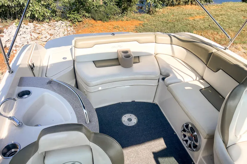 Slide: The Image of 2007 Sea Ray 260 Sundeck interior with cushioned seating and cup holders. - 21