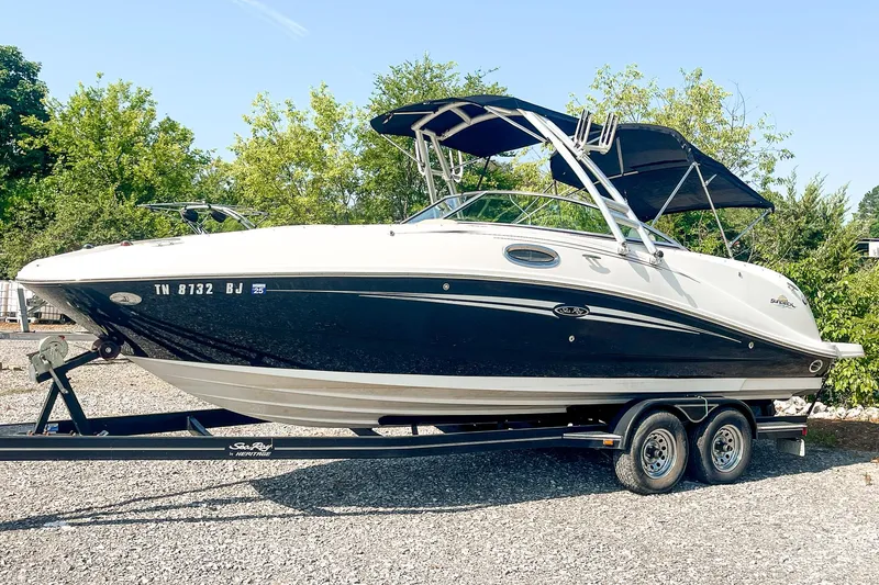 Slide: The Image of 2007 Sea Ray 260 Sundeck boat on trailer, black and white design, parked outdoors. - 4