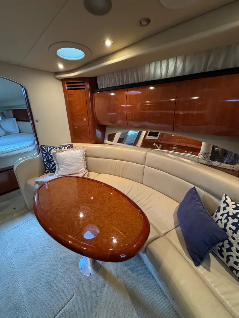 Slide: The Image of Luxurious interior of 2010 Sea Ray 360DA yacht with elegant seating and wooden table. - 12