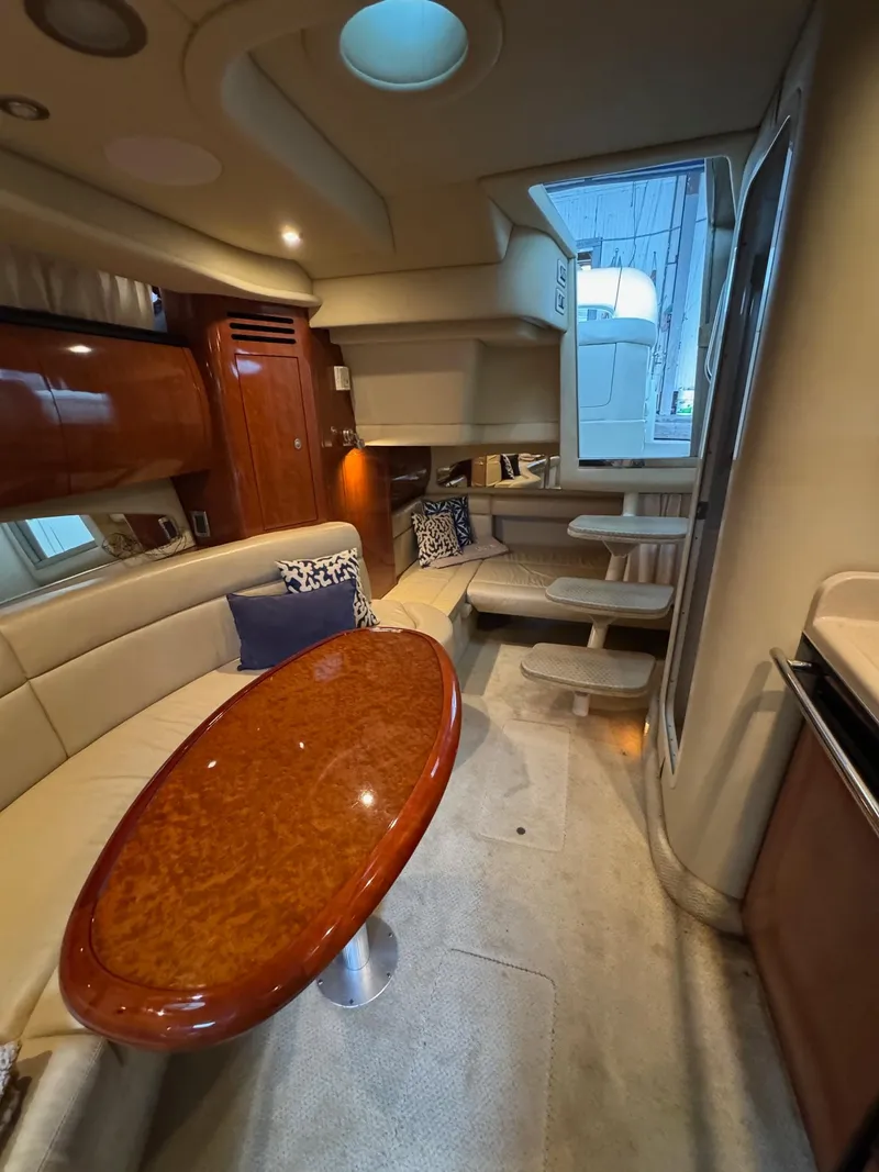 Slide: The Image of Luxurious interior of 2010 Sea Ray 360DA yacht with elegant seating and wooden table. - 13