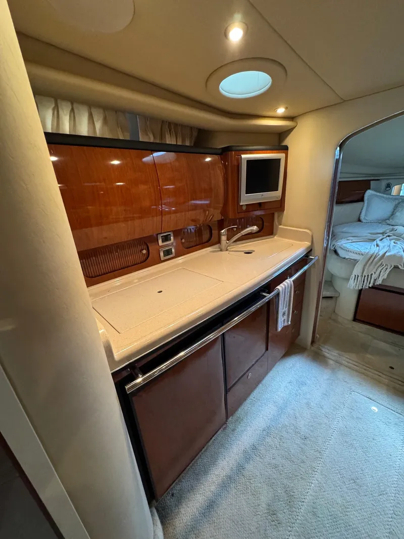Slide: The Image of Luxurious interior of 2010 Sea Ray 360DA yacht with modern kitchenette and cozy sleeping area. - 14