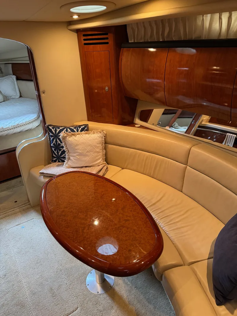 Slide: The Image of Luxurious interior of 2010 Sea Ray 360DA yacht with leather seating and wooden table. - 15