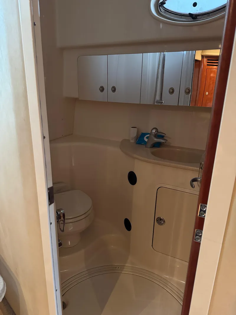 Slide: The Image of Compact bathroom in a 2010 Sea Ray 360DA yacht, featuring a toilet and sink. - 18