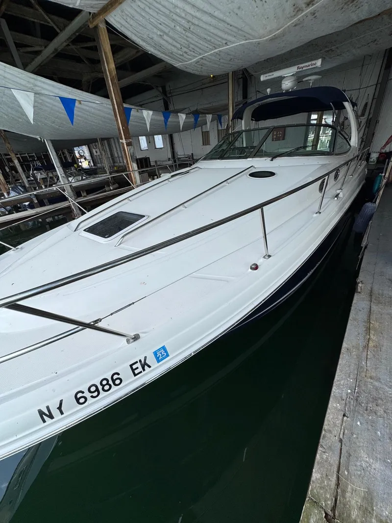 Slide: The Image of 2010 Sea Ray 360DA boat docked in a covered marina. - 2