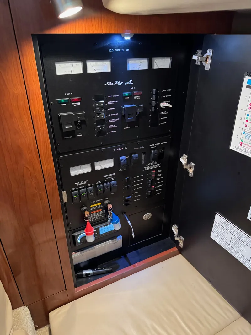 Slide: The Image of Electrical panel inside a 2010 Sea Ray 360DA boat, featuring various switches and controls. - 20