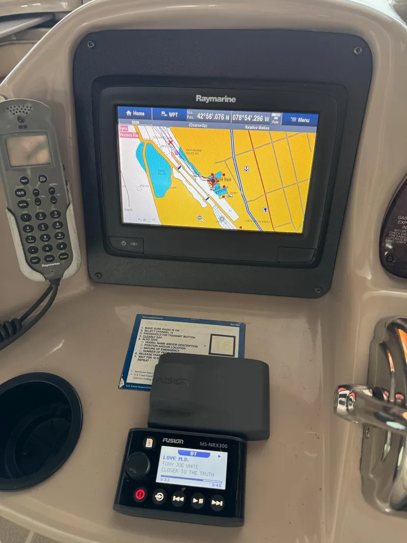 Slide: The Image of Control panel of a 2010 Sea Ray 360DA with navigation and audio systems. - 24