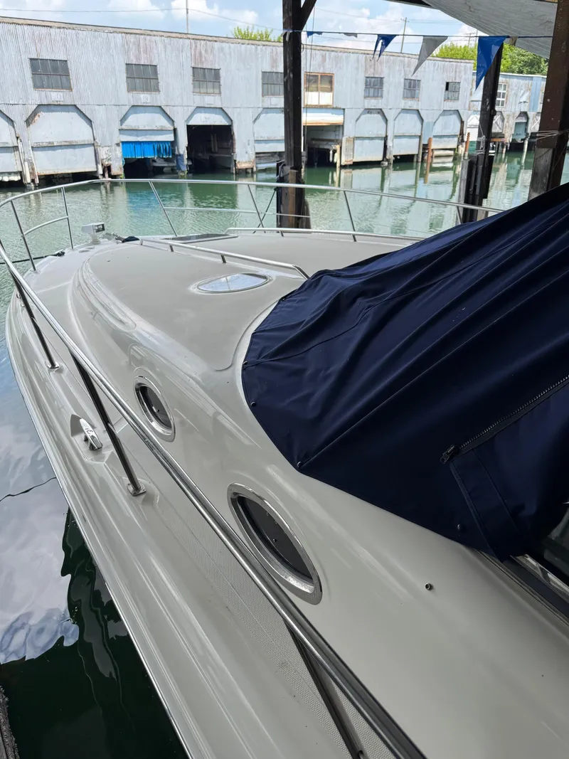 Slide: The Image of 2010 Sea Ray 360DA yacht docked, featuring sleek design and covered cockpit. - 5