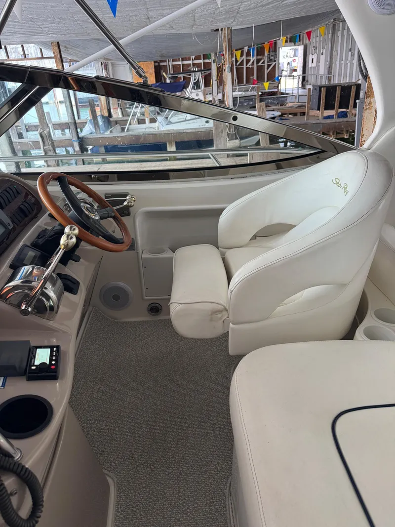 Slide: The Image of Interior of 2010 Sea Ray 360DA boat with white captain's chair and control panel. - 8