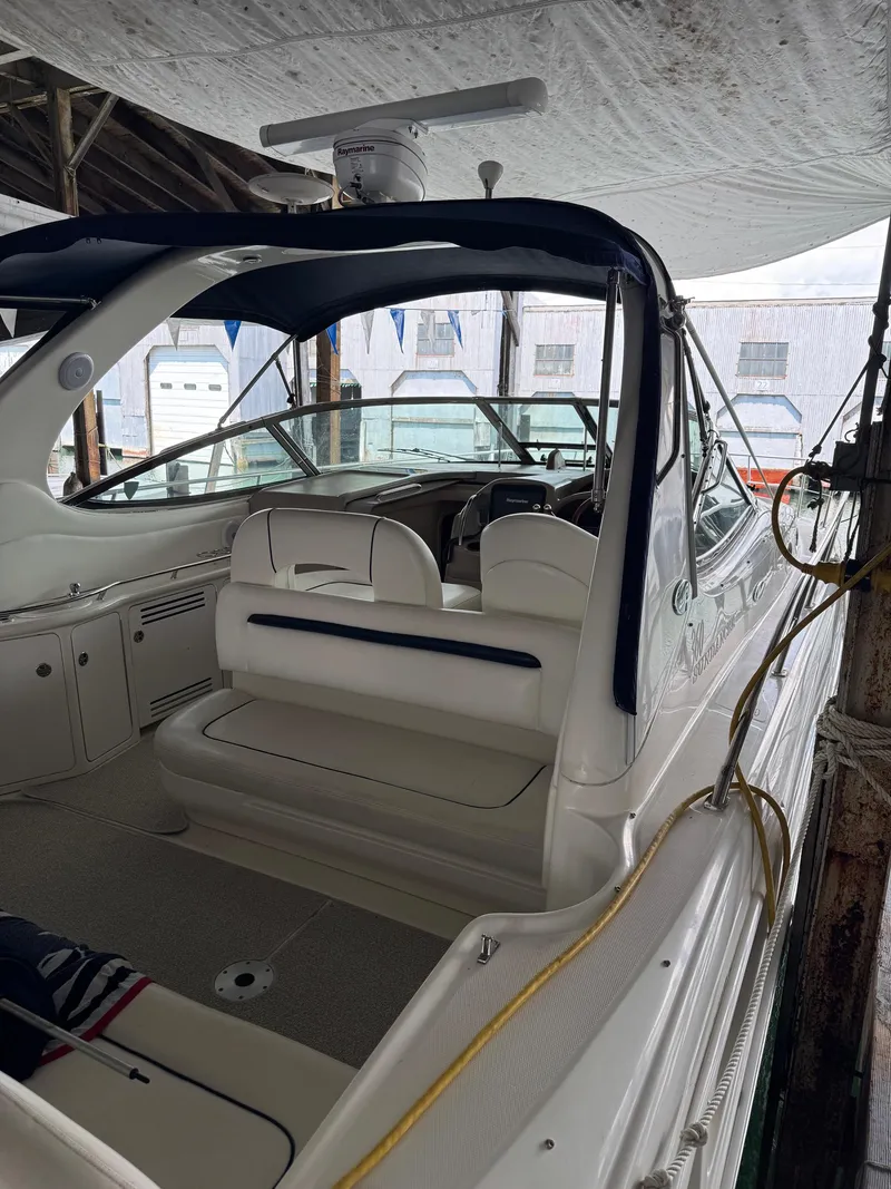 Slide: The Image of 2010 Sea Ray 360DA boat interior with seating and helm under a canopy. - 9