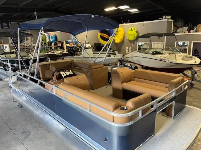 Slide: The Image of 2025 Tahoe Pontoon SP 2180 CR with tan seating in a showroom. - 10