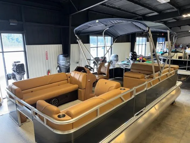Slide: The Image of 2025 Tahoe Pontoon SP 2180 CR with tan seating and canopy in showroom. - 12