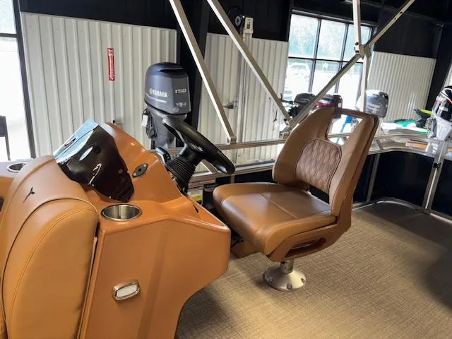 Slide: The Image of 2025 Tahoe Pontoon SP 2180 CR interior with brown captain's chair and Yamaha engine. - 14