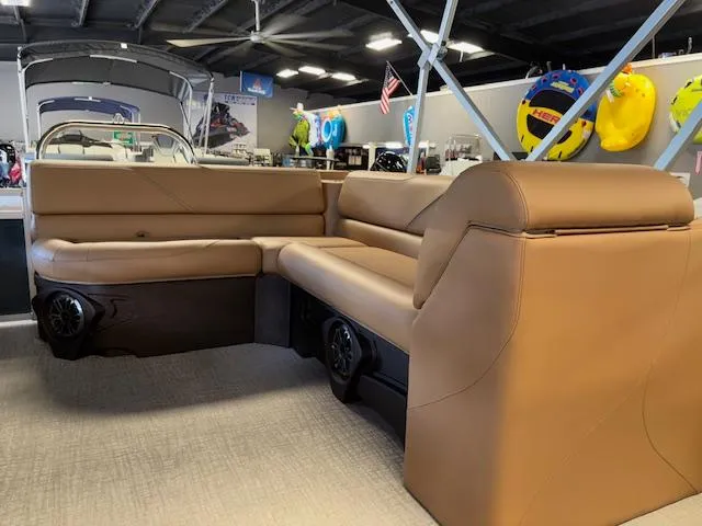 Slide: The Image of 2025 Tahoe Pontoon SP 2180 CR interior with tan seating in showroom. - 15