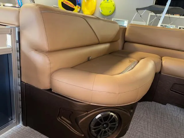 Slide: The Image of 2025 Tahoe Pontoon SP 2180 CR with tan leather seating and built-in speaker. - 16