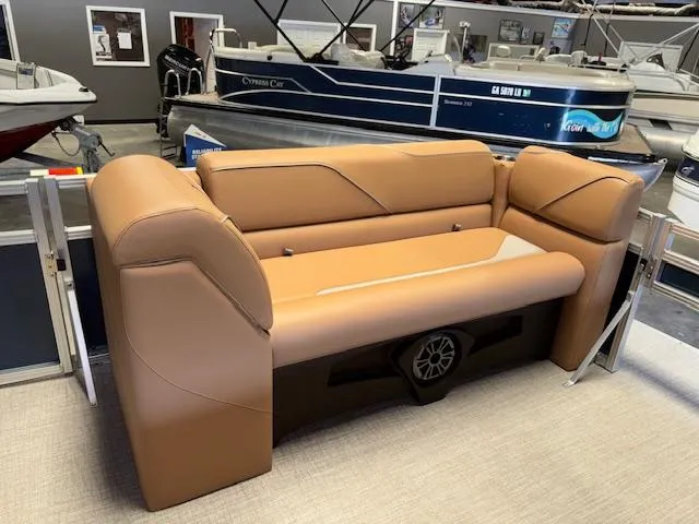 Slide: The Image of 2025 Tahoe Pontoon SP 2180 CR boat seating in showroom, featuring tan upholstery. - 17
