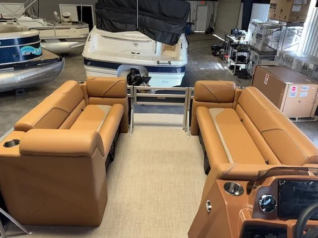 Slide: The Image of 2025 Tahoe Pontoon SP 2180 CR with tan seating in a showroom. - 19