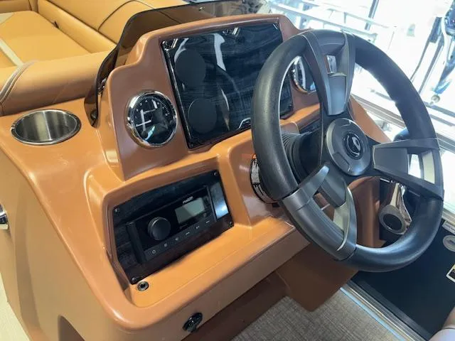 Slide: The Image of 2025 Tahoe Pontoon SP 2180 CR dashboard with steering wheel and controls. - 21