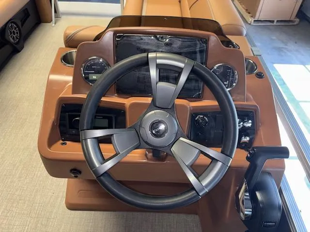 Slide: The Image of 2025 Tahoe Pontoon SP 2180 CR dashboard with steering wheel and controls. - 22
