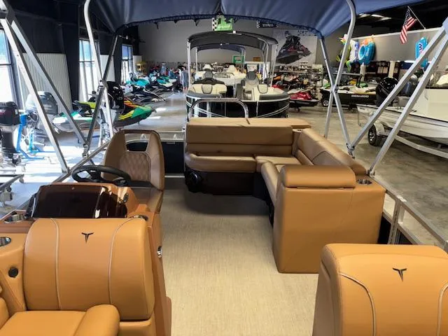 Slide: The Image of 2025 Tahoe Pontoon SP 2180 CR interior with tan seating in a showroom. - 25
