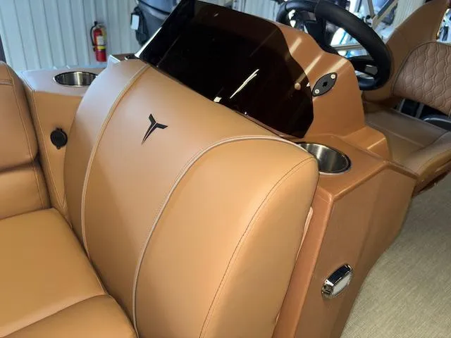 Slide: The Image of 2025 Tahoe Pontoon SP 2180 CR interior with tan leather seats and steering console. - 28