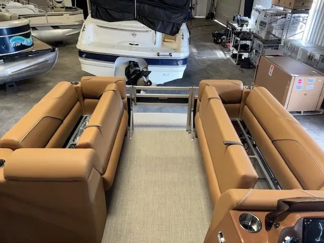 Slide: The Image of 2025 Tahoe Pontoon SP 2180 CR interior with tan seating in a showroom. - 29