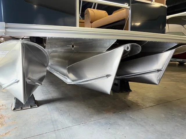 Slide: The Image of 2025 Tahoe Pontoon SP 2180 CR with sleek aluminum pontoons in a showroom. - 3