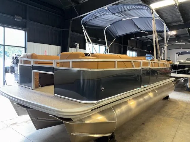 Slide: The Image of 2025 Tahoe Pontoon SP 2180 CR with canopy in a showroom setting. - 5