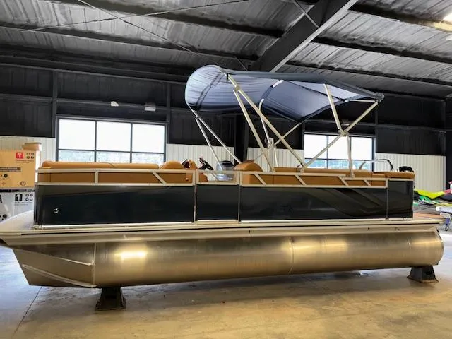 Slide: The Image of 2025 Tahoe Pontoon SP 2180 CR in a warehouse, featuring a sleek design and canopy. - 6