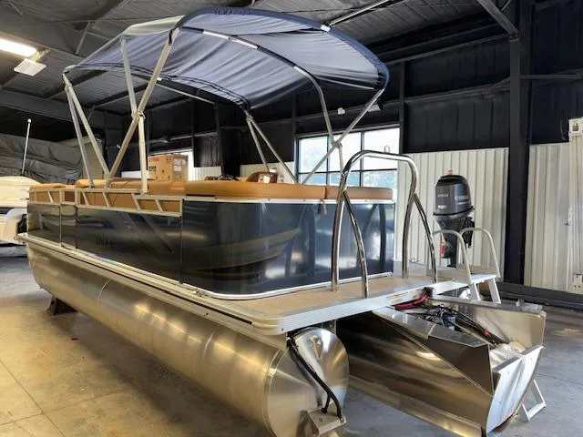 Slide: The Image of 2025 Tahoe Pontoon SP 2180 CR in a showroom, featuring a sleek design and canopy. - 7
