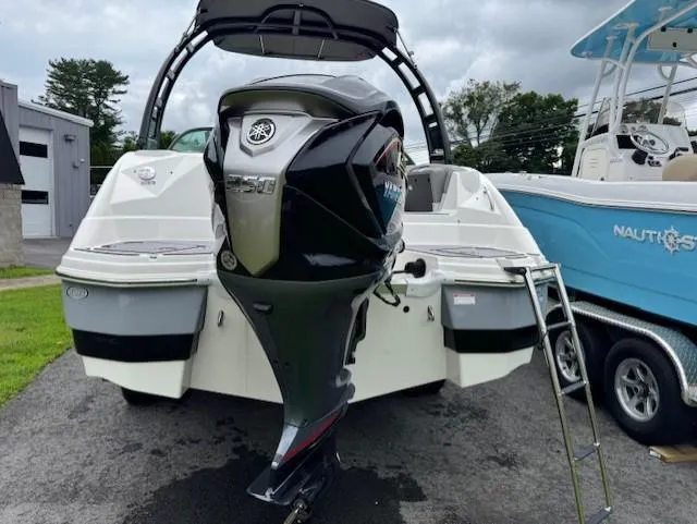 Slide: The Image of 2023 NauticStar 243 DC boat with Yamaha outboard motor, parked on a driveway. - 4