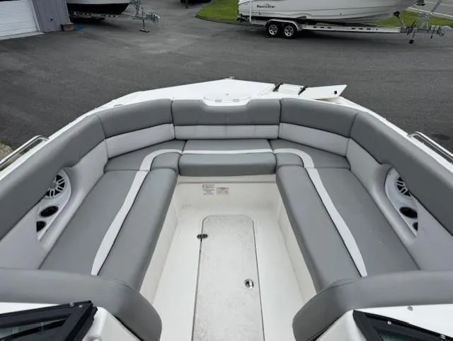 Slide: The Image of 2023 NauticStar 243 DC boat with spacious gray seating and modern design. - 8