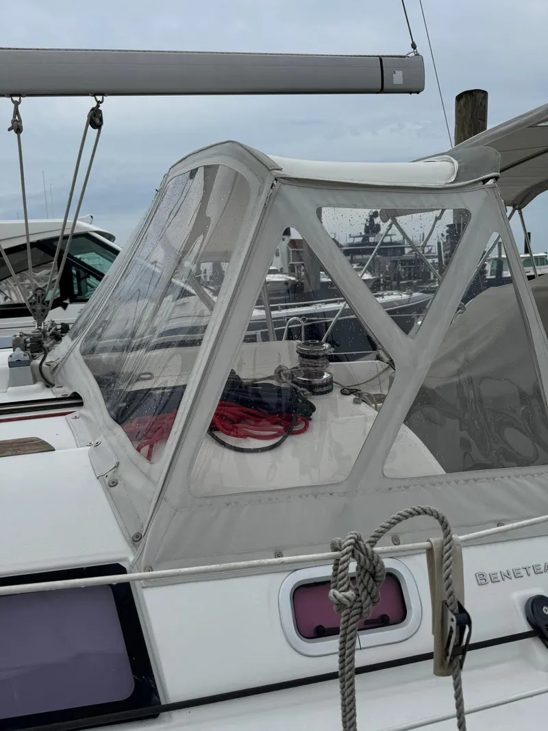 Slide: The Image of 2014 Beneteau 37 sailboat with clear cockpit enclosure at marina. - 10
