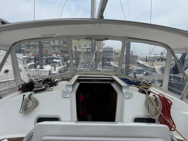 Slide: The Image of Cockpit view of a 2014 Beneteau 37 sailboat docked at a marina. - 13