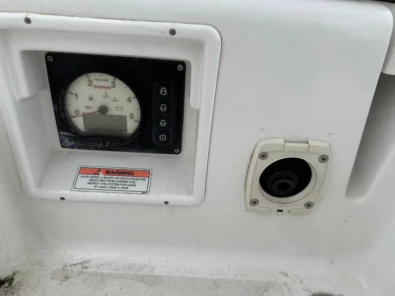 Slide: The Image of Control panel of a 2014 Beneteau 37 sailboat with warning label and gauge. - 14