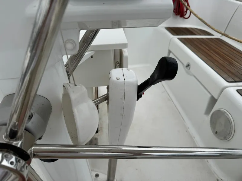 Slide: The Image of Cockpit controls of a 2014 Beneteau 37 sailboat, featuring a throttle lever and seating area. - 15