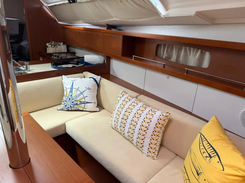 Slide: The Image of Interior of 2014 Beneteau 37 yacht with cozy seating and decorative pillows. - 24
