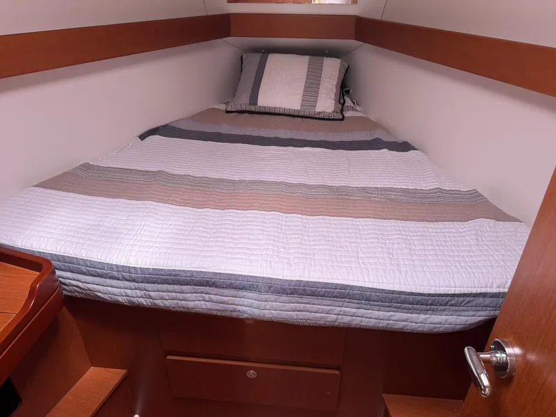 Slide: The Image of Cozy cabin interior of 2014 Beneteau 37 sailboat with striped bedding. - 26