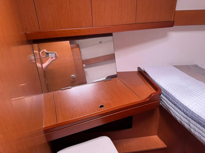 Slide: The Image of Interior of 2014 Beneteau 37 yacht with wooden desk and mirror in cabin. - 27