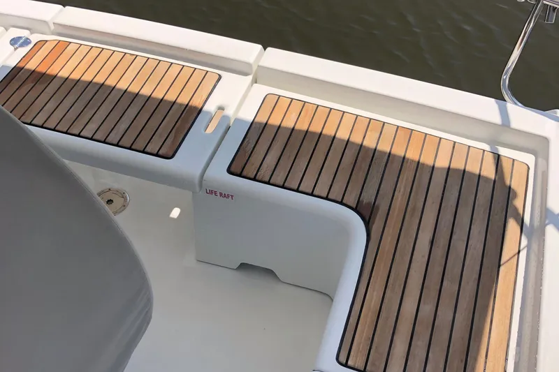 Slide: The Image of Teak deck of 2014 Beneteau 37 sailboat with life raft compartment. - 29
