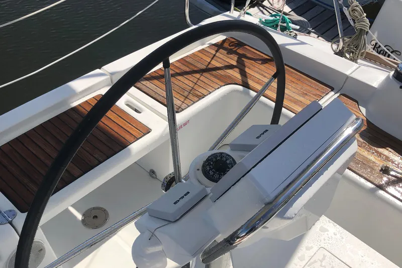Slide: The Image of Steering wheel and compass on a 2014 Beneteau 37 sailboat deck. - 30