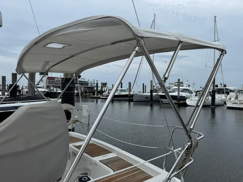 Slide: The Image of 2014 Beneteau 37 sailboat with bimini top docked at marina. - 5