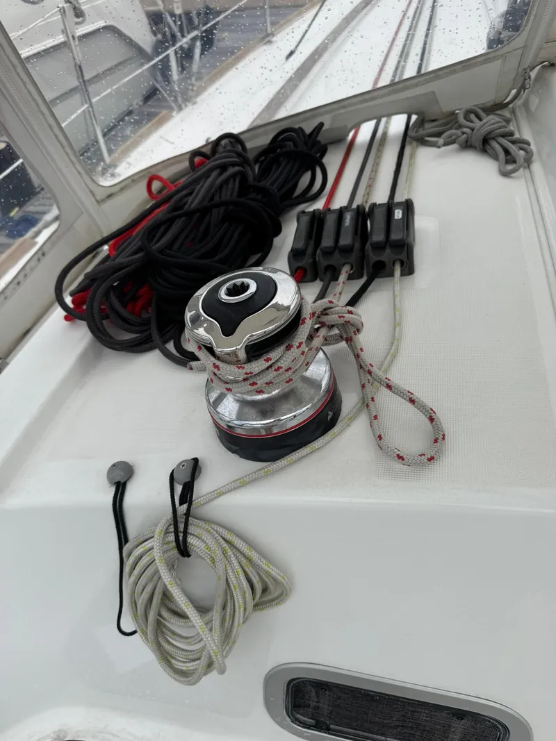 Slide: The Image of 2014 Beneteau 37 sailboat deck with winch and ropes. - 9