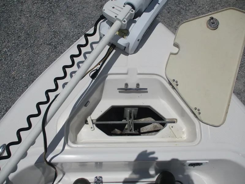 Slide: The Image of 2008 Key West 186 Sportsmen boat anchor compartment with open hatch and trolling motor. - 6